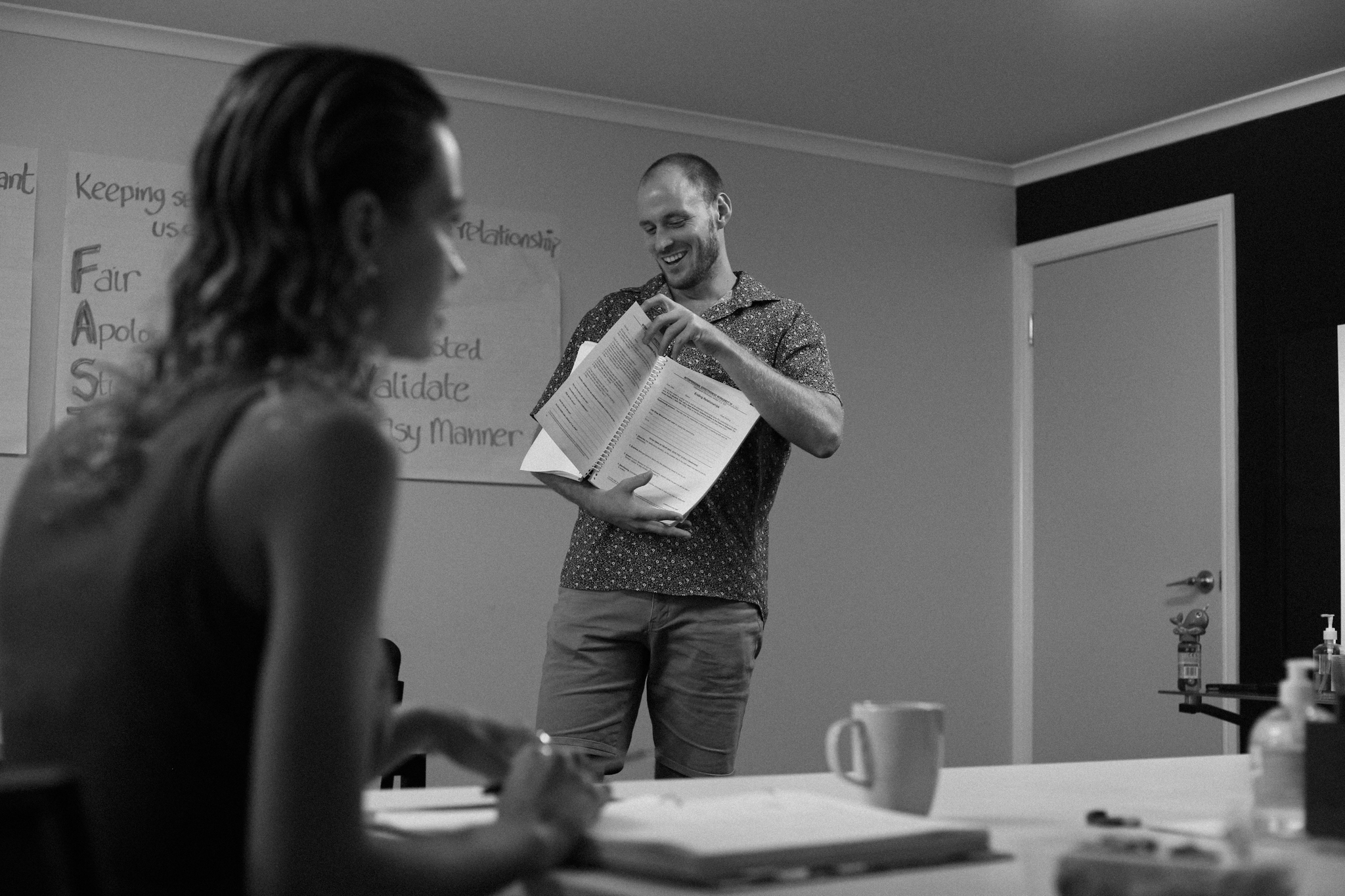 Life Mental Health DBT facilitator laughing warmly while presenting to the group